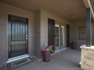 The front porch is large enough for seating and co