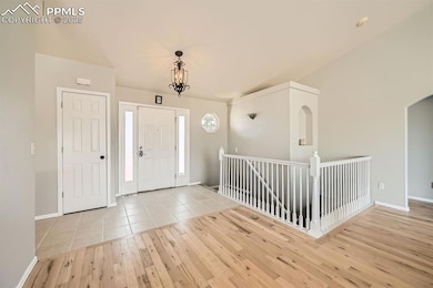 Entrance foyer with baseboards, arched walkways, a