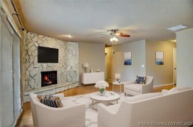 Family room with floor to ceiling stone fireplace.