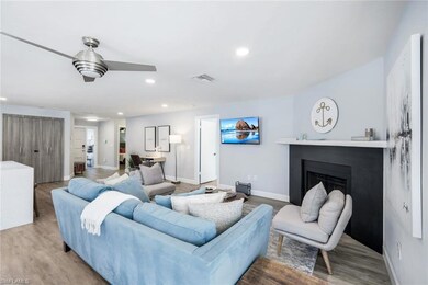 Living room with ceiling fan and hardwood / wood-s