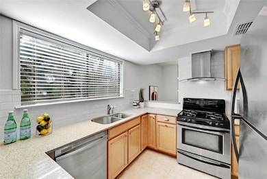 Kitchen with a raised ceiling, appliances with st