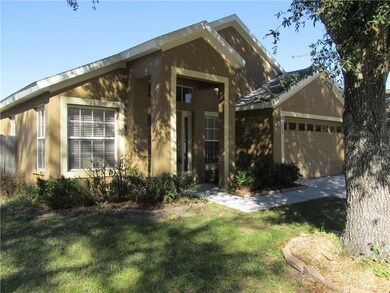 Covered entry & a nice big shady oak greet you as 