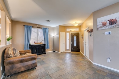 Foyer entrance featuring stone tile flooring and b