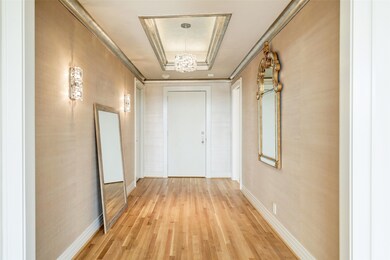 Formal entry has seagrass wall covering and tray c