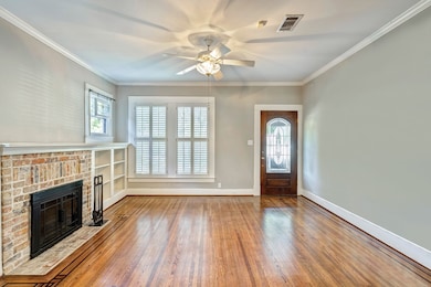 Enjoy this beautiful  living area with hardwoods through out the home @ two stain glass windows on each side of the fireplace.(Recently closed right side of wall of picture to make secondary bedroom a true second bedroom).