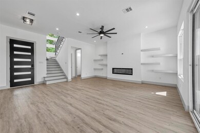 Unfurnished living room featuring ceiling fan and 