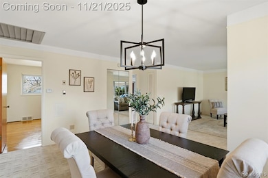 Dining room featuring a chandelier and light colored carpet