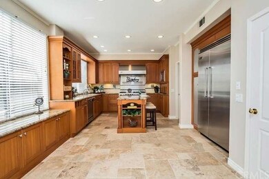 Custom Kitchen has maple cabinetry, eat at island 