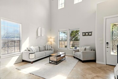 Living room with a towering ceiling, plenty of na