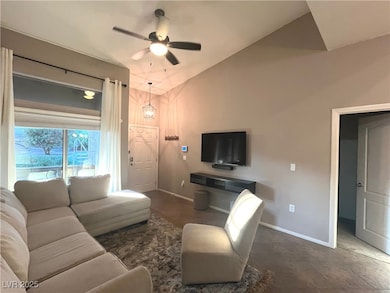 Family room with vaulted ceilings, ceiling fan & light that opens to the dining area and kitchen.