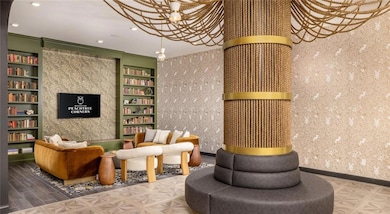 Community lobby with crown molding, wallpapered walls, and recessed lighting