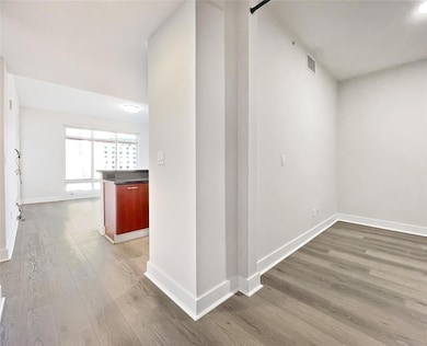 Hall with wood finished floors and baseboards