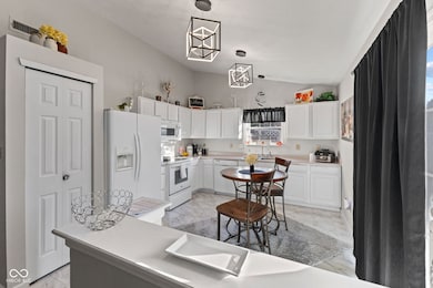 Kitchen featuring vaulted ceiling.