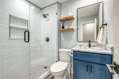 Bathroom on first floor featuring an enclosed show
