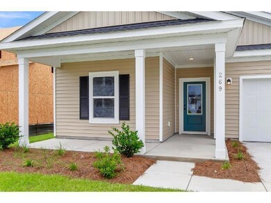 Entrance to property with a garage and a porch
