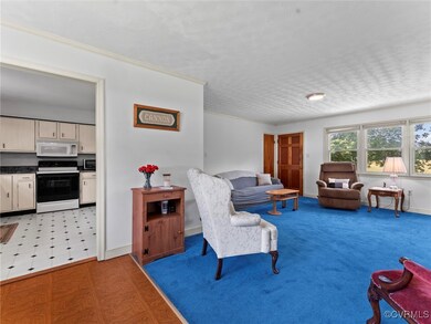 Living area featuring light floors and baseboards