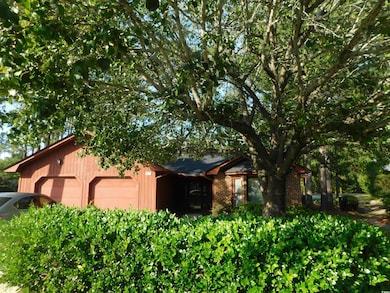 View of front of home with brick siding and a detached garage