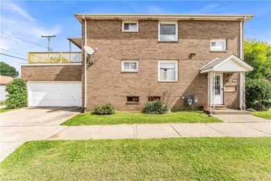 View of front of house with balcony, garage, and a