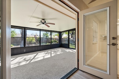 Unfurnished sunroom with a ceiling fan