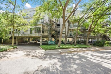 View of community with driveway and a carport