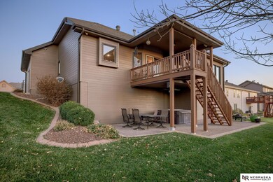 Back of the home has a covered deck with fantastic views. It also has shades, outdoor ceiling fan, built-in speakers, & a gas connection for grill. Walk directly out the basement onto a large 