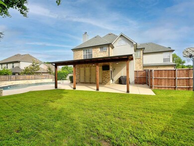 Perfect yard with green space, covered patio, and pool!