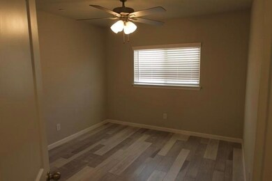 Empty room featuring ceiling fan and hardwood / wood-style floors