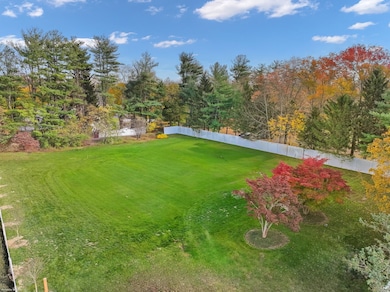 Photo virtually altered to represent rendering of land without existing structures currently present on property