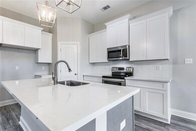 Quartz countertops, gray island, large lantern pen
