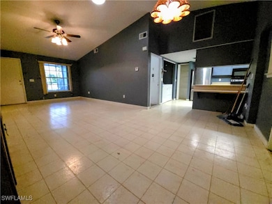 Unfurnished living room featuring ceiling fan, lig