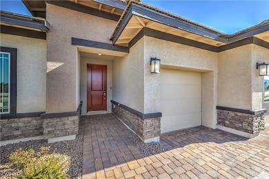 Property entrance with stone siding, stucco siding