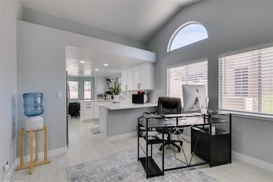 Office space with light wood-type flooring, lofted