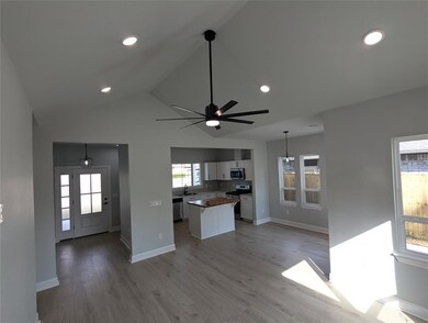 Kitchen featuring a center island, white cabinetry