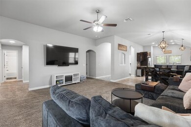 Living area featuring arched walkways, a ceiling f