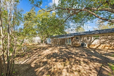 Rear view of property with brick siding and a patio