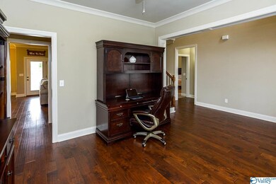 and continue throughout the main living area. The dining room also boasts crown molding, a ceiling fan, and new paint.