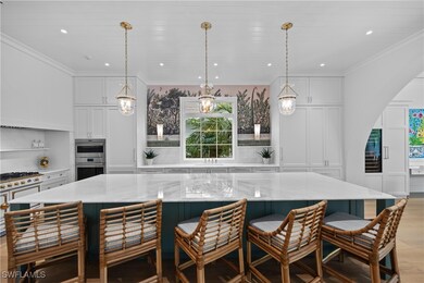 Kitchen with a breakfast bar, white cabinets, a sp