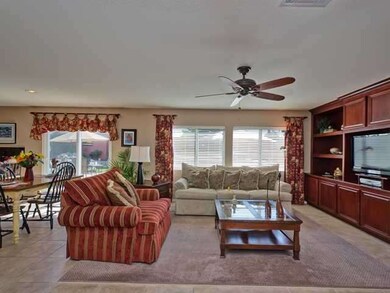 Travertine flooring, built-in shelves, ceiling fan