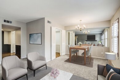 Living and dining room virtually staged. On far le