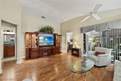 Living room with visible vents, a fireplace, wood