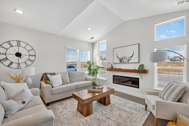 Living room with vaulted ceilings and fireplace.
