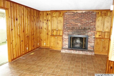 Spacious family room with gas fireplace. Next to kitchen.