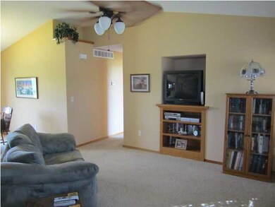 Living room has vaulted ceilings and great windows