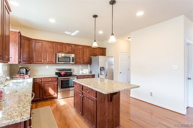 Kitchen with tiled backsplash and pendant and rece