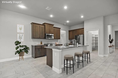 Kitchen with a kitchen island with sink, a kitchen