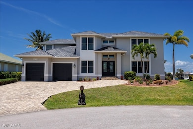 2 Story home featuring french doors, 2 car garage, a front yard, stucco finish, and paver driveway