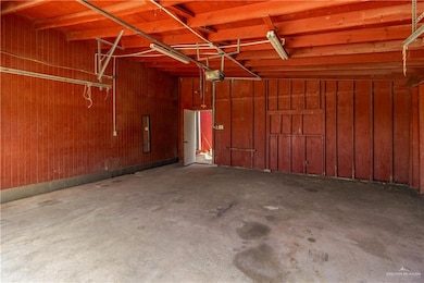 Garage featuring wood walls and a garage door opener