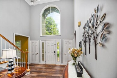 The impressive two story entry is sunlit with the
