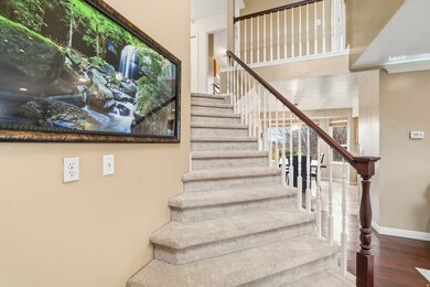 Stairs with wood finished floors and baseboards