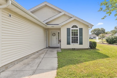 Doorway to property featuring a lawn